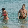 Brian Ray, guitarist for Paul McCartney, and his girlfriend enjoy the sun on a beach.