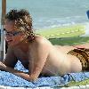 Brian Ray, guitarist for Paul McCartney, and his girlfriend enjoy the sun on a beach.