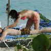 Brian Ray, guitarist for Paul McCartney, and his girlfriend enjoy the sun on a beach.