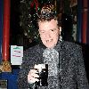 Madness lead singer Graham 'Suggs' McPherson stops by at McDaid's Pub on Harry Street for a festive pint of Guinness before heading off to play in Belfast tonight..