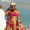 Stacy Keibler with straw hat and bikini at the Fontainbleau Hotel Resort on Miami Beach.