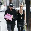 Johnny Hallyday carries two pink boxes as he leaves La Conversation Cafe with his wife Laetitia in West Hollywood.Los Angeles, California. Johnny Hallyday carries two pink boxes as he leaves La Conversation Cafe with his wife Laetitia in West Hollywood.Los Angeles, California.
