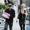 Johnny Hallyday carries two pink boxes as he leaves La Conversation Cafe with his wife Laetitia in West Hollywood.Los Angeles, California.