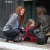 English actress Rebecca Mader stops to chat to a friend while out shopping with her daughter in Hollywood..