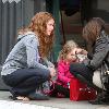 English actress Rebecca Mader stops to chat to a friend while out shopping with her daughter in Hollywood..