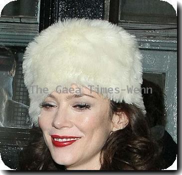 Anna Friel leaves the Royal Haymarket Theatre in a white fur hat and wearing a white crochet dress, during a snowy night after her evening performance of 'Breakfast at Tiffany's' London.