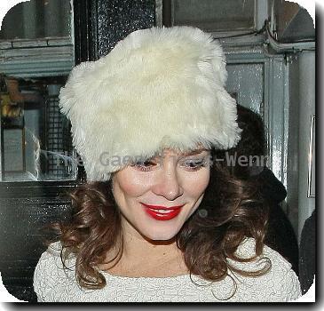 Anna Friel leaves the Royal Haymarket Theatre in a white fur hat and wearing a white crochet dress, during a snowy night after her evening performance of 'Breakfast at Tiffany's' London.