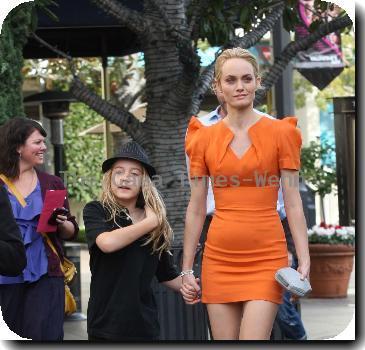 Amber Valletta wearing an orange dress while out shopping in Hollywood with her son Auden. Los Angeles, California.