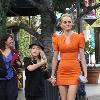 Amber Valletta wearing an orange dress while out shopping in Hollywood with her son Auden. Los Angeles, California.