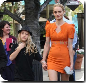 Amber Valletta wearing an orange dress while out shopping in Hollywood with her son Auden. Los Angeles, California.