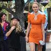 Amber Valletta wearing an orange dress while out shopping in Hollywood with her son Auden. Los Angeles, California.