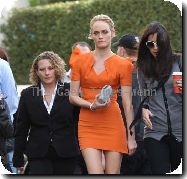 Amber Valletta wearing an orange dress while out shopping in Hollywood with her son Auden. Los Angeles, California.