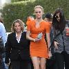 Amber Valletta wearing an orange dress while out shopping in Hollywood with her son Auden. Los Angeles, California.