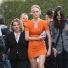 Amber Valletta wearing an orange dress while out shopping in Hollywood with her son Auden. Los Angeles, California.