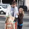 Ashley Tisdale rides on a shopping cart pushed by her boyfriend Scott Speer as they leave Trader Joe's grocery store in Toluca Lake..