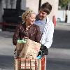 Ashley Tisdale rides on a shopping cart pushed by her boyfriend Scott Speer as they leave Trader Joe's grocery store in Toluca Lake..