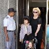 Hugh Jackman props up a parasol during a family holiday at the Copacabana Palace Hotel Rio De Janeiro.