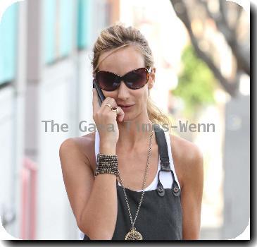 Lady Victoria Hervey grabs a pizza for lunch and chats on her mobile phone while taking her dogs for a walk. Los Angeles, California.