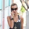 Lady Victoria Hervey grabs a pizza for lunch and chats on her mobile phone while taking her dogs for a walk. Los Angeles, California.