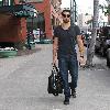 Jesse Metcalfe carries a leather duffel bag while on his way to a business meeting in Beverly Hills.