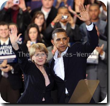 U.S. President Barack Obama joins Martha Coakley, the attorney general of Massachusetts and Democratic candidate for the U.S. Senate, during a campaign rally.