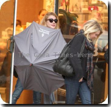 Alyson Michalka still wearing sunglasses, braves the rain as she opens her Four Seasons hotel umbrella leaving Anastasia salon in Beverly Hills Los Angeles.