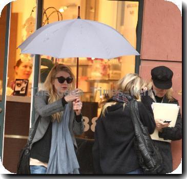 Alyson Michalka still wearing sunglasses, braves the rain as she opens her Four Seasons hotel umbrella leaving Anastasia salon in Beverly Hills Los Angeles.