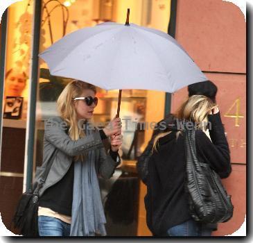 Alyson Michalka still wearing sunglasses, braves the rain as she opens her Four Seasons hotel umbrella leaving Anastasia salon in Beverly Hills Los Angeles.