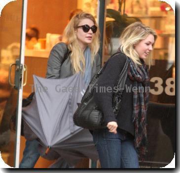 Alyson Michalka still wearing sunglasses, braves the rain as she opens her Four Seasons hotel umbrella leaving Anastasia salon in Beverly Hills Los Angeles.