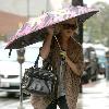 Brittany Snow walking in the rain in decorative studded boots after getting her eyebrows done at Anastasia in Beverly Hills Los Angeles.