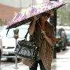 Brittany Snow walking in the rain in decorative studded boots after getting her eyebrows done at Anastasia in Beverly Hills Los Angeles.