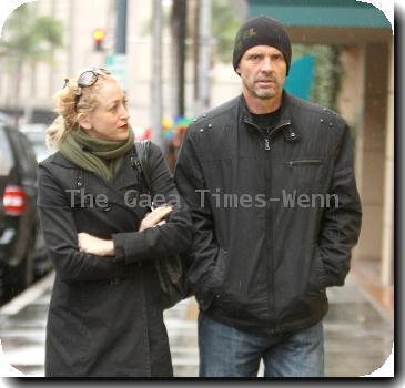 Michael Biehn out and about in Beverly Hills wearing a beiny hat in the rain walking with Jennifer BlancLos Angeles.