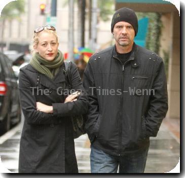 Michael Biehn out and about in Beverly Hills wearing a beiny hat in the rain walking with Jennifer BlancLos Angeles.