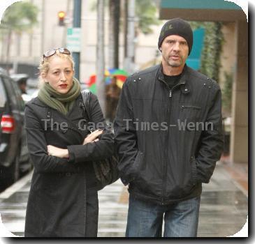 Michael Biehn out and about in Beverly Hills wearing a beiny hat in the rain walking with Jennifer BlancLos Angeles.