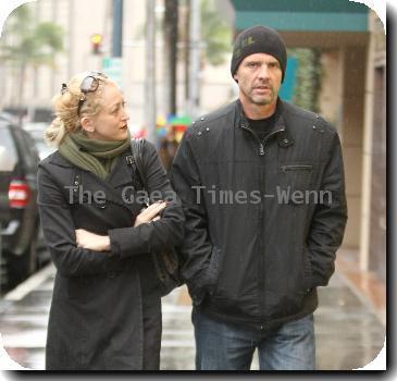 Michael Biehn out and about in Beverly Hills wearing a beiny hat in the rain walking with Jennifer BlancLos Angeles.