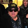 Danny DeVito arriving at Tegel Airport wearing a 'It's Always Sunny In Philadelphia' baseball cap. Berlin.