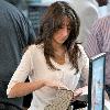 Danielle Deleasa 
newlywed arriving at LAX to catch a flight while wearing brown boots.