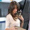 Danielle Deleasa 
newlywed arriving at LAX to catch a flight while wearing brown boots.