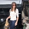 Danielle Deleasa 
newlywed arriving at LAX to catch a flight while wearing brown boots.