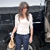 Danielle Deleasa 
newlywed arriving at LAX to catch a flight while wearing brown boots.