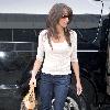 Danielle Deleasa 
newlywed arriving at LAX to catch a flight while wearing brown boots.