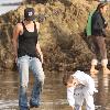 Victoria Beckham and Cruz Beckham

 playing walking the beach.