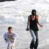 Victoria Beckham and Cruz Beckham

 playing walking the beach.