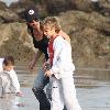 Victoria Beckham and Cruz Beckham

 playing walking the beach.