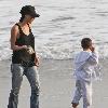 Victoria Beckham and Cruz Beckham

 playing walking the beach.