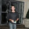 Simon Cowell leaving his hotel in flared jeans and a packet of KOOL brand menthol cigarettes London.