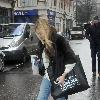 Fearne Cotton running to her car to avoid the rain after leaving the BBC Radio 1 studios London.