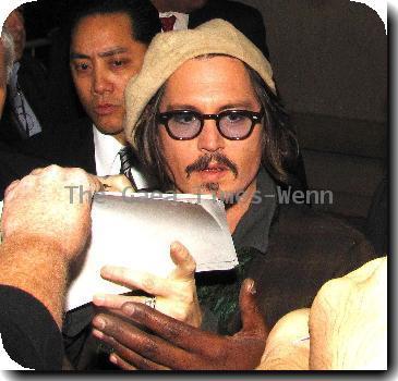 Johnny Depp signs autographs for fans outside Hot Topic after attending 'Alice In Wonderland' Great Big Ultimate Fan Event Los Angeles.