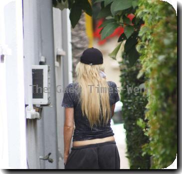 Sophie Monk talking in her mobile phone after putting out the trash near her home.A scar is visible on her right hip, as a result from a car accident earlier this year (10)Los Angeles.