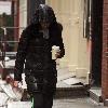 Julianna Margulies seen trudging through the rain and sleet after working out at a gym in Soho. New York City.